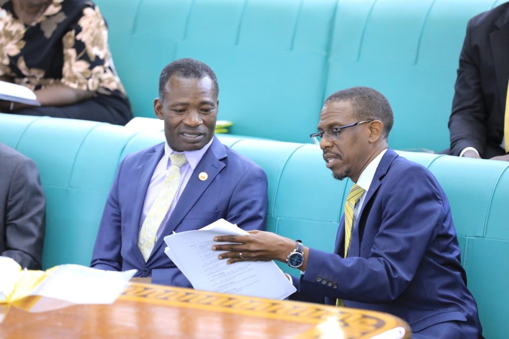 Committee chairperson, Hon. James Kubeketerya (L) and Attorney General Kiryowa Kiwanuka consulting on some aspects of the Bill