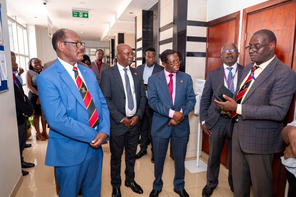 Left to Right: Prof. Barnabas Nawangwe, Prof. Edward Bbaale, Prof. Buyinza Mukadasi, Prof. Sam Luboga and Dr. Andrew Kambugu chat during a tour of the facility.