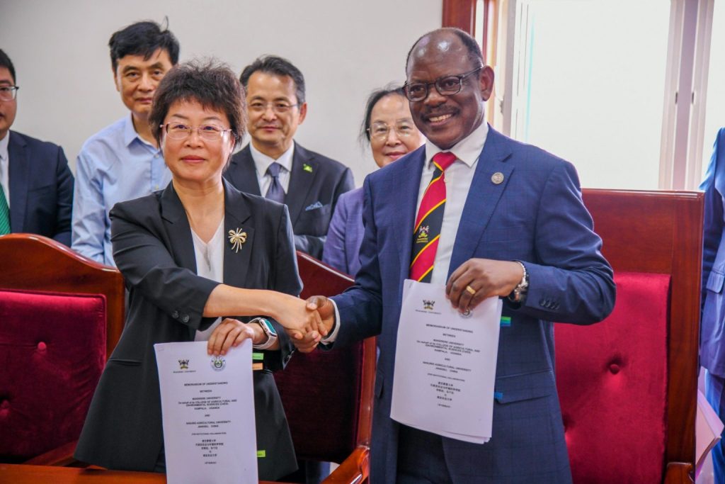 Prof. Barnabas Nawangwe (Right) and Prof. Zhu Yan (Left) shake hands as they display the signed MoU on 28th July 2025.